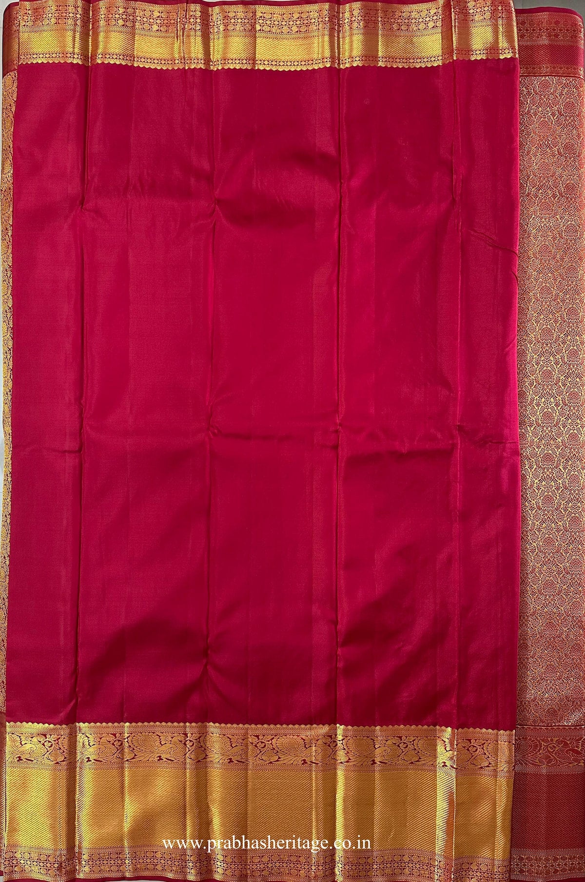 Attached crimson-red running blouse with a broad gold zari peacock border