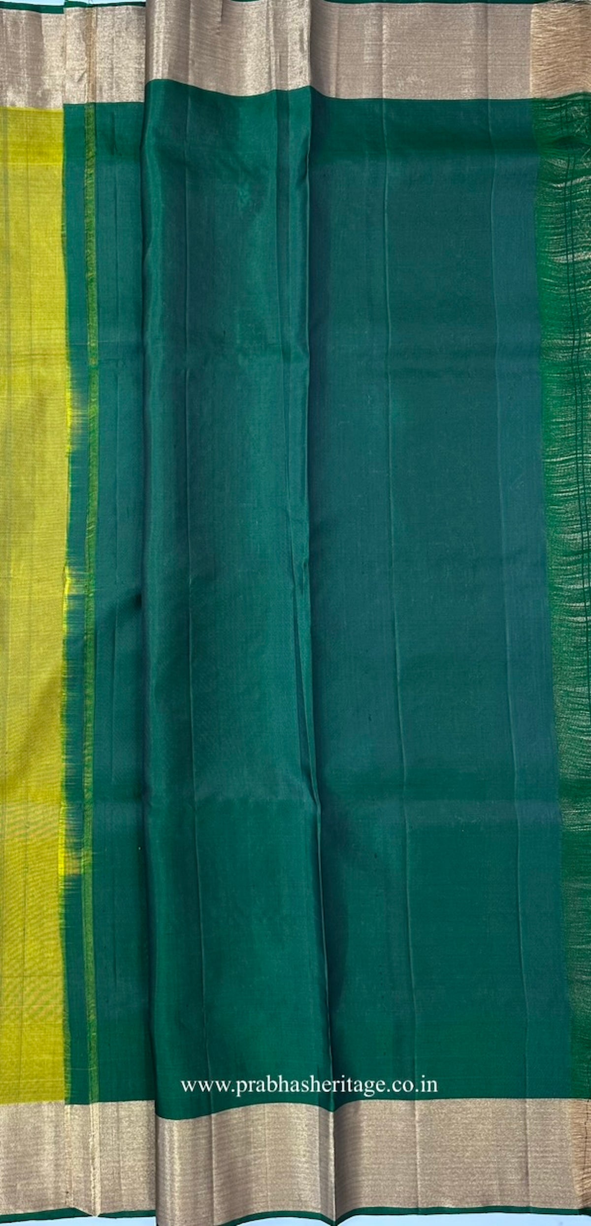 Attached deep-green blouse piece with a zari border