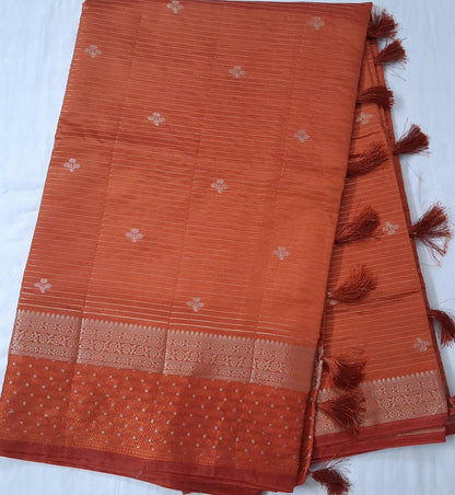 Long fold view of Arunodayam Varnam copper orange semi-tussar saree with zari border