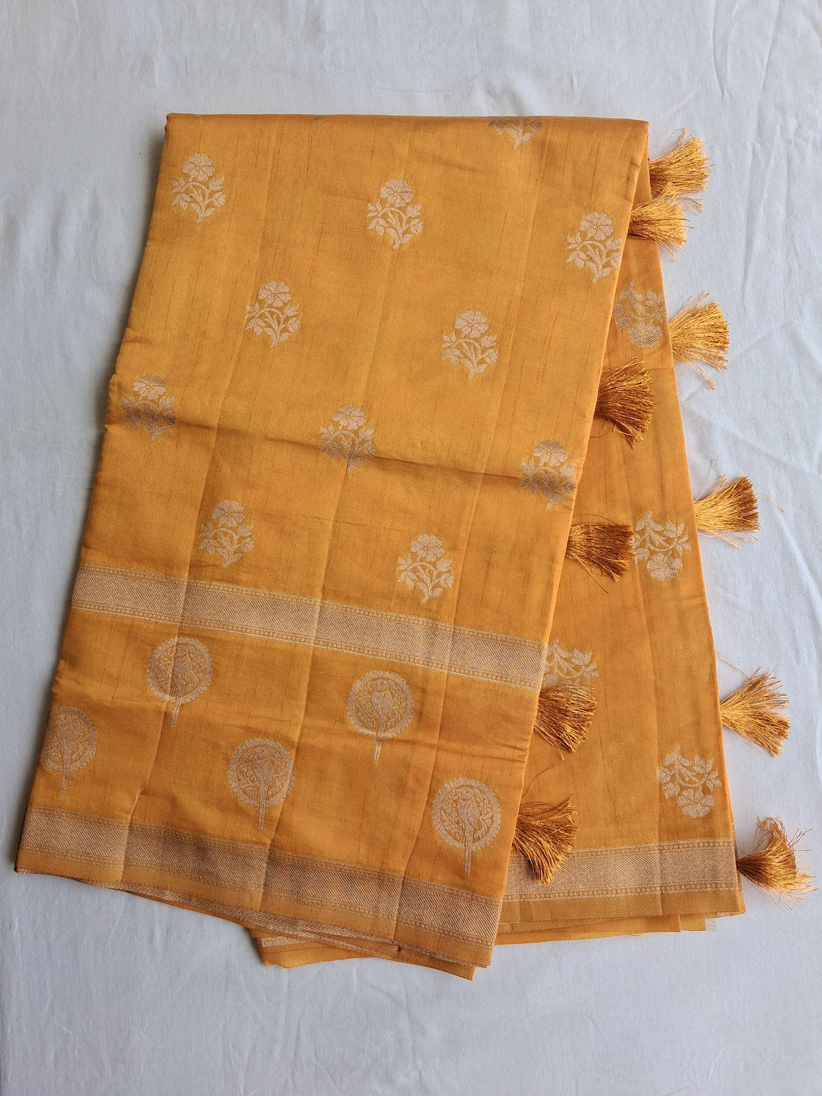 Long fold view of Kanaka Varnam golden semi-tussar saree with zari border