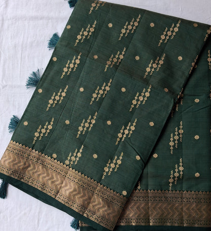 Long fold view of Vanashree Varnam forest green semi-tussar saree with zari border