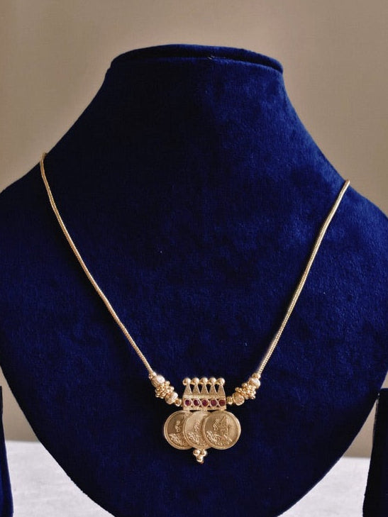 Three Coin Lakshmi Pendant Mala – traditional South Indian temple jewellery with three Lakshmi coin pendants and ruby-tone accents displayed on a mannequin