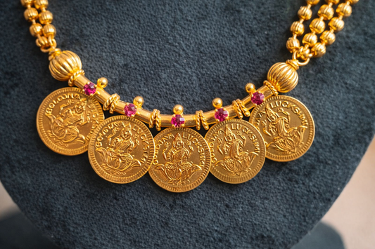 Mid-length Five Lakshmi Coin Kasumala Necklace close-up – traditional South Indian temple jewellery featuring Lakshmi coin pendants, ruby-tone stones and multi-strand gold-tone bead chain