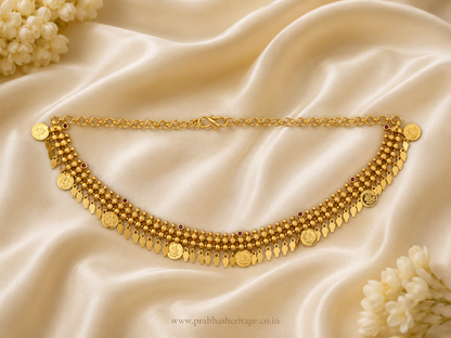 Swarna Kasu Ilakkathali choker shown as a flat lay on ivory satin