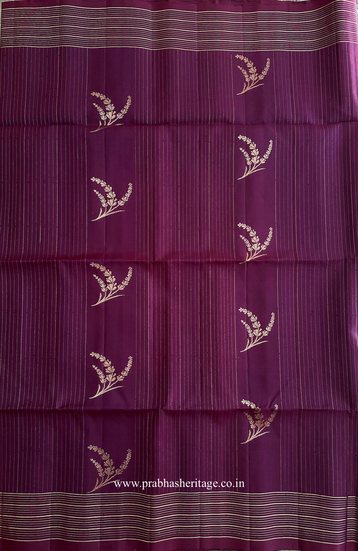 Fine gold-toned linear pattern with botanical sprigs on the plum silk body