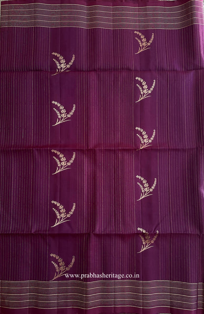 Fine gold-toned linear pattern with botanical sprigs on the plum silk body