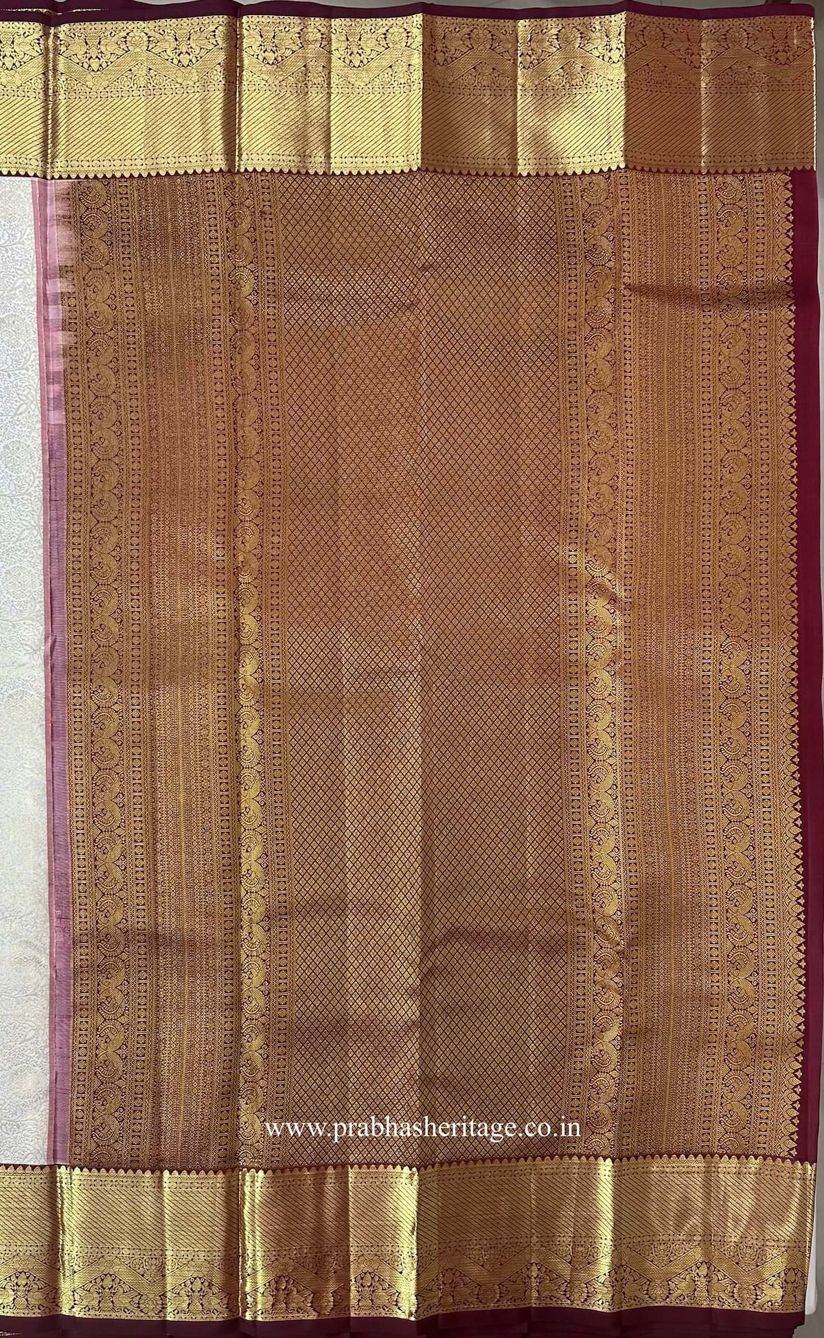 Pallu with a diamond-lattice field and peacock motifs in wine and gold zari