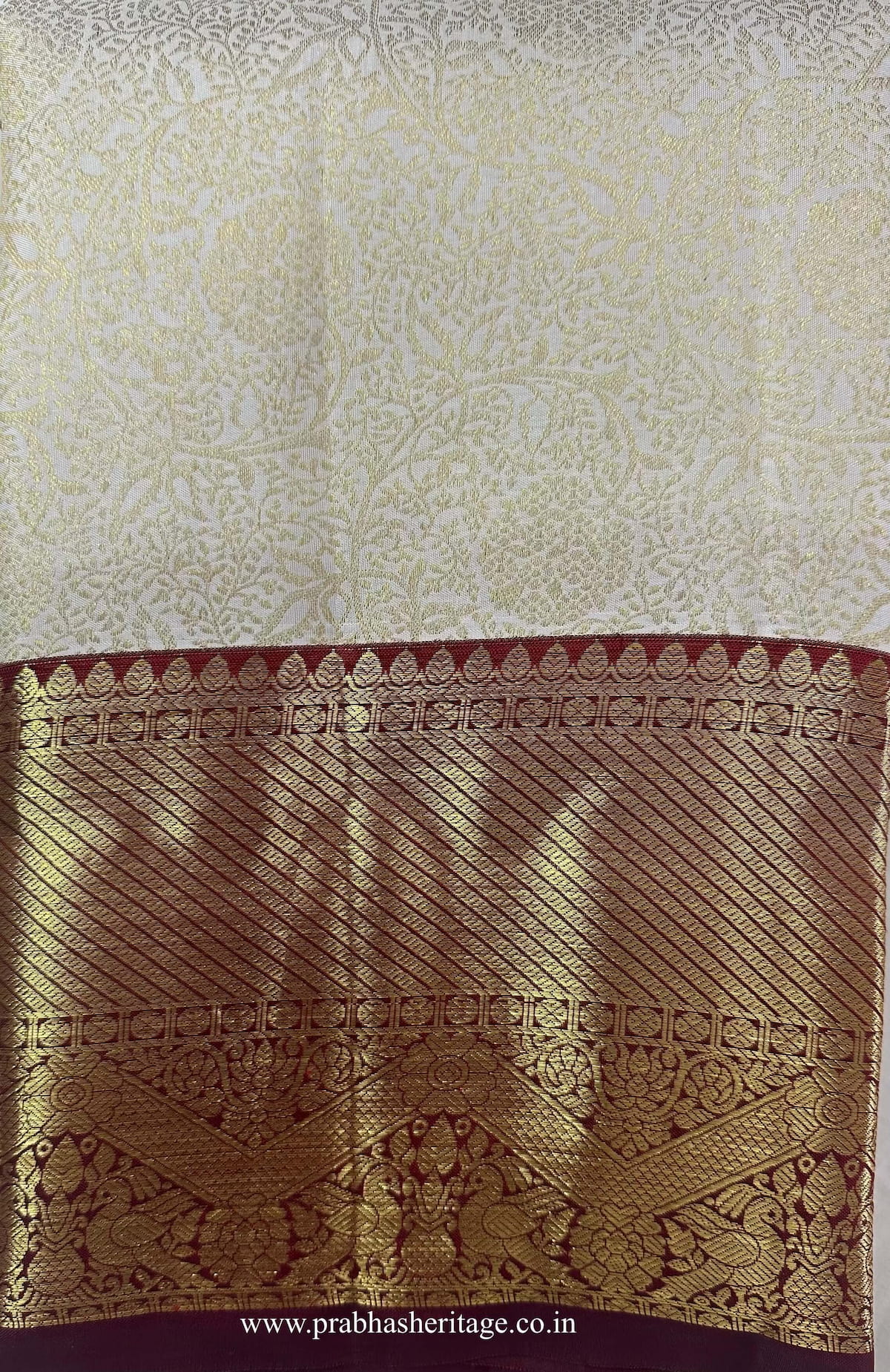 Anandabhairavi Madhura Layam saree folded to show the body and wine Korvai border