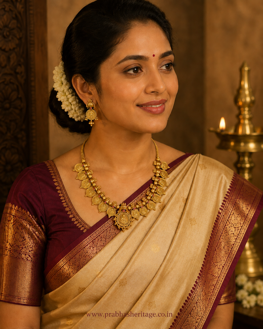 Antique gold Kasumala with ruby-toned stones and a central Mahalakshmi medallion, worn