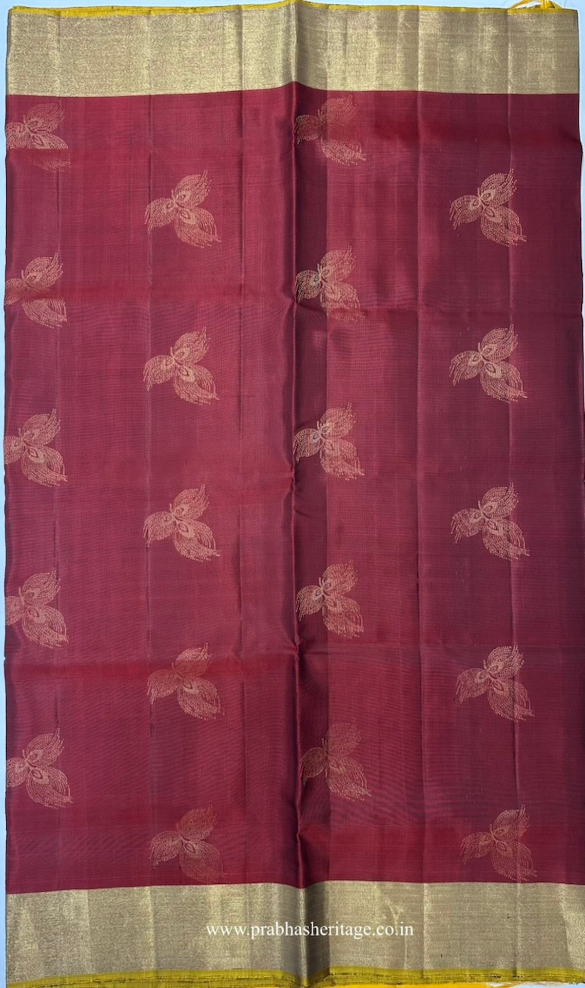 Stylised floral bud motifs on the maroon-red silk body