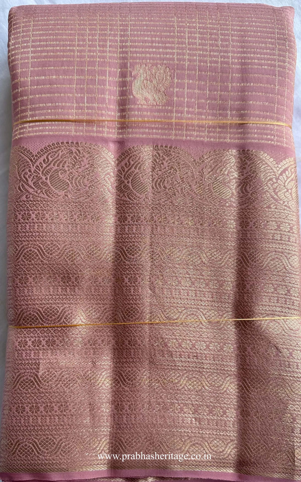 Hamsanandi Swarna Naadam short-folded to show the mauve pink body with zari check pattern and border