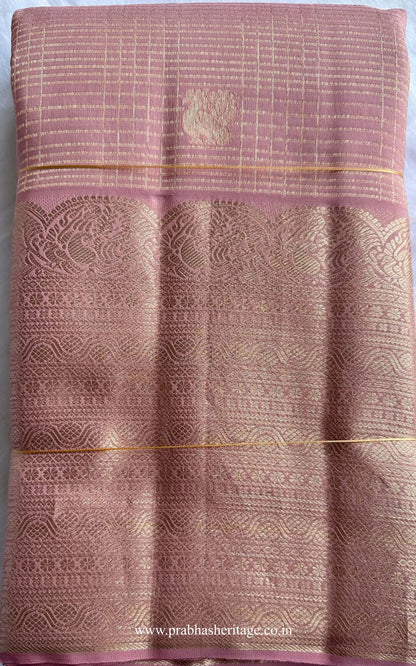 Hamsanandi Swarna Naadam short-folded to show the mauve pink body with zari check pattern and border