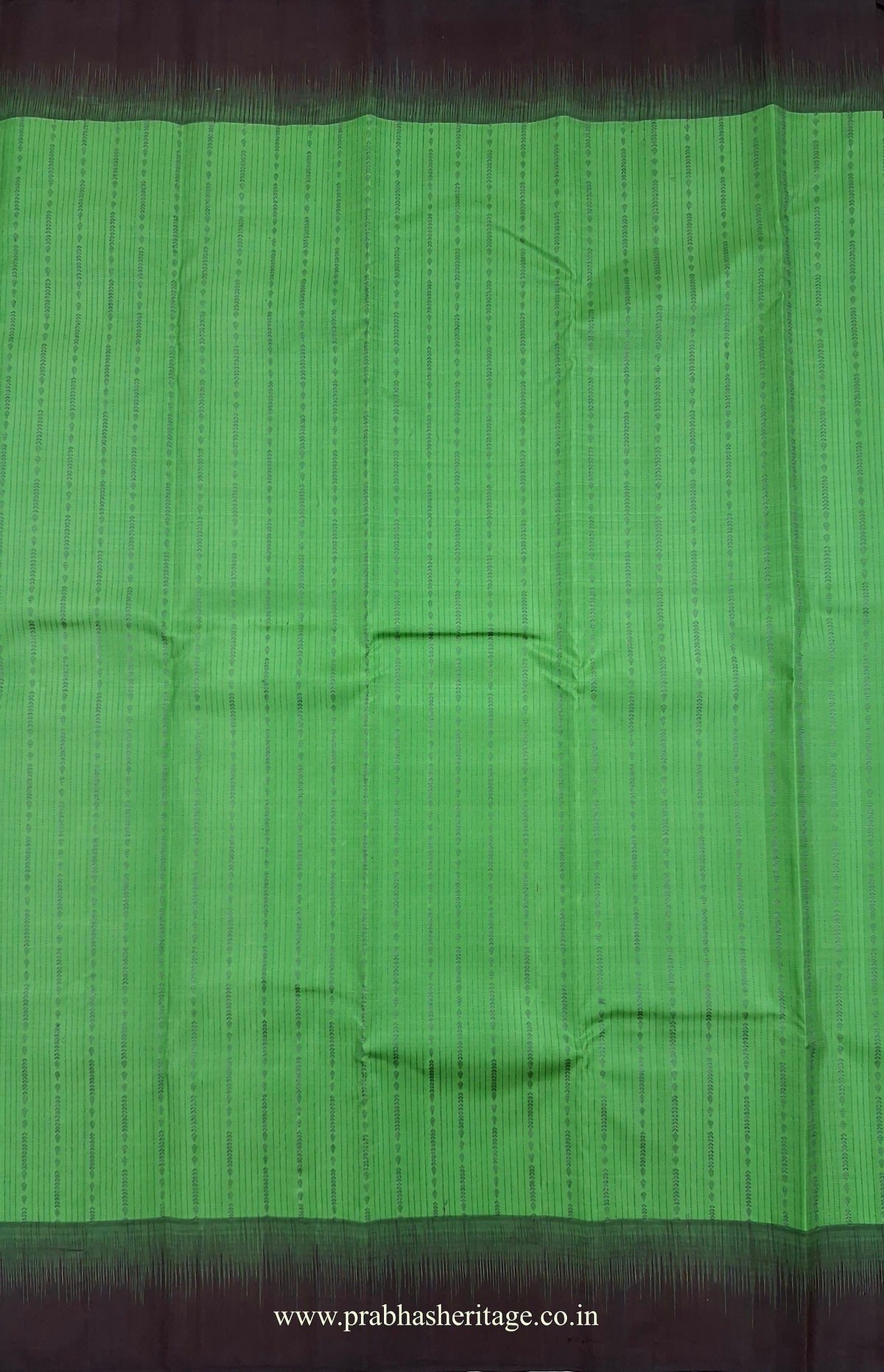 Fine vertical woven lines and ornamental detailing on the parrot-green silk body