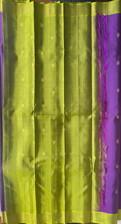 Korvai join where the jamun purple body meets the parrot-green zari border