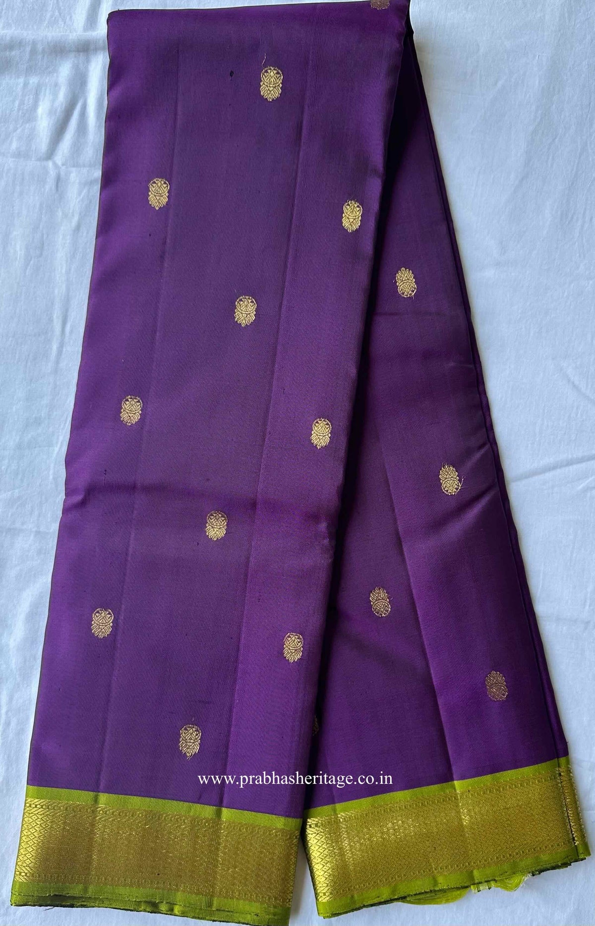 Full length of the jamun purple Kanchipuram silk saree with its parrot-green Korvai border
