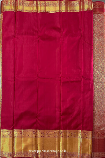 Attached crimson-red running blouse with a broad gold zari peacock border