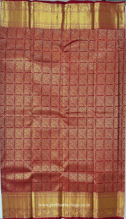 All-over gold zari floral grid on the red silk body of the saree