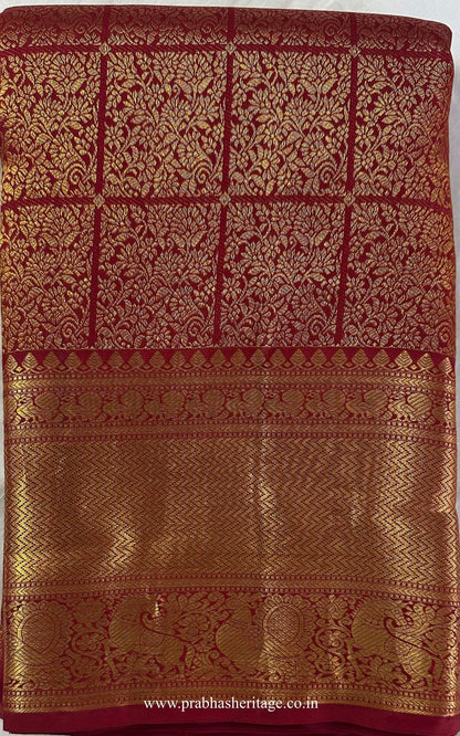 Kalyani Suvarna Mangalyam saree folded to show the body and broad gold zari border