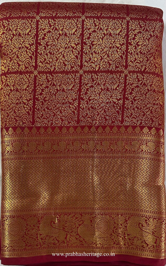 Kalyani Suvarna Mangalyam saree folded to show the body and broad gold zari border