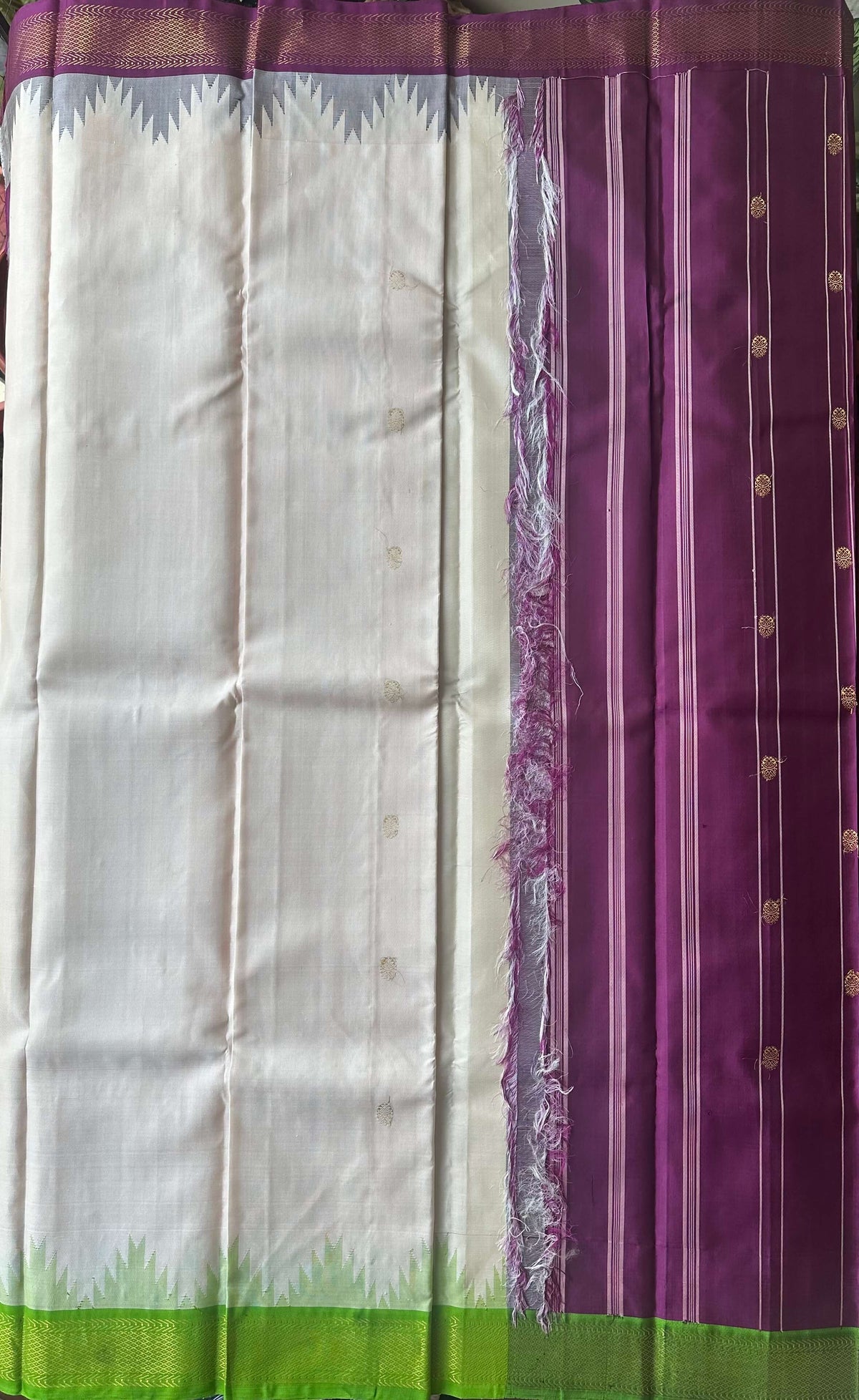 Korvai join where the ivory body meets the burgundy and leaf green zari border