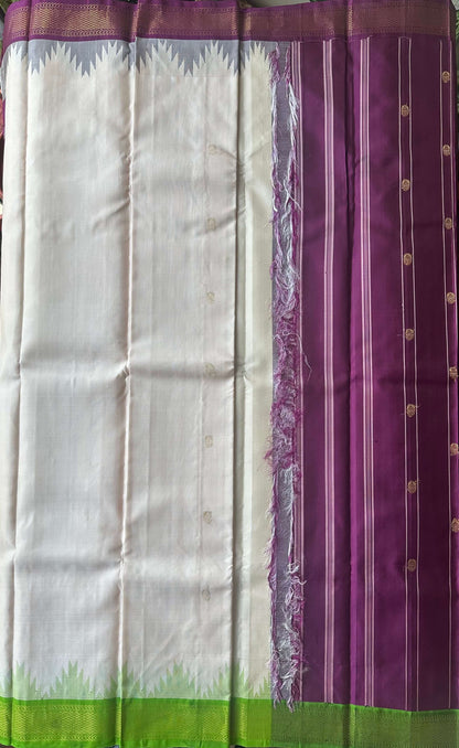 Korvai join where the ivory body meets the burgundy and leaf green zari border