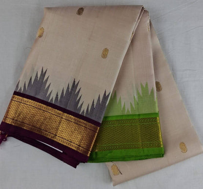 Ivory Kanchipuram silk saree folded to show the body and burgundy Korvai border