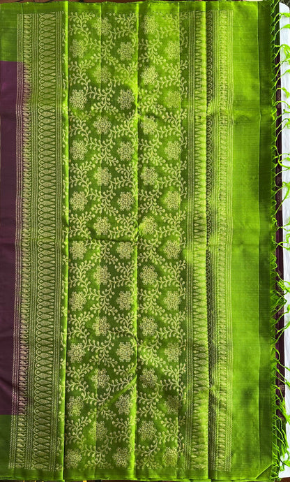 Leaf-green pallu with subtle zari patterning and structured detailing