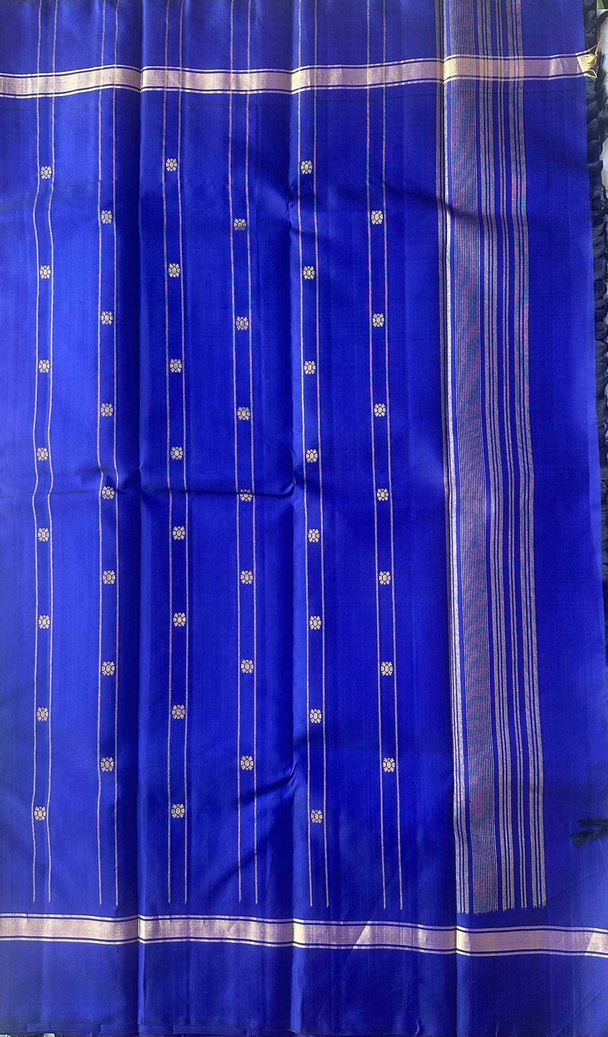 Royal blue pallu worked in gold zari on a leaf green Kanchipuram silk saree