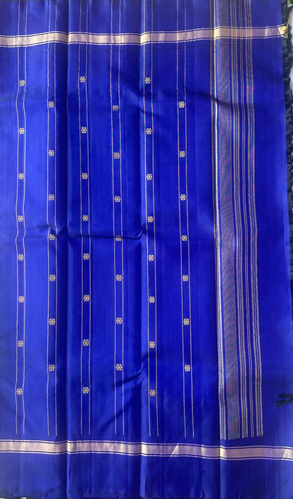 Royal blue pallu worked in gold zari on a leaf green Kanchipuram silk saree