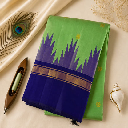 Leaf green handloom pure Kanchipuram silk saree with a royal blue Korvai temple border