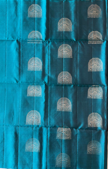 Temple arch–inspired geometric zari buttas on the deep peacock teal silk body