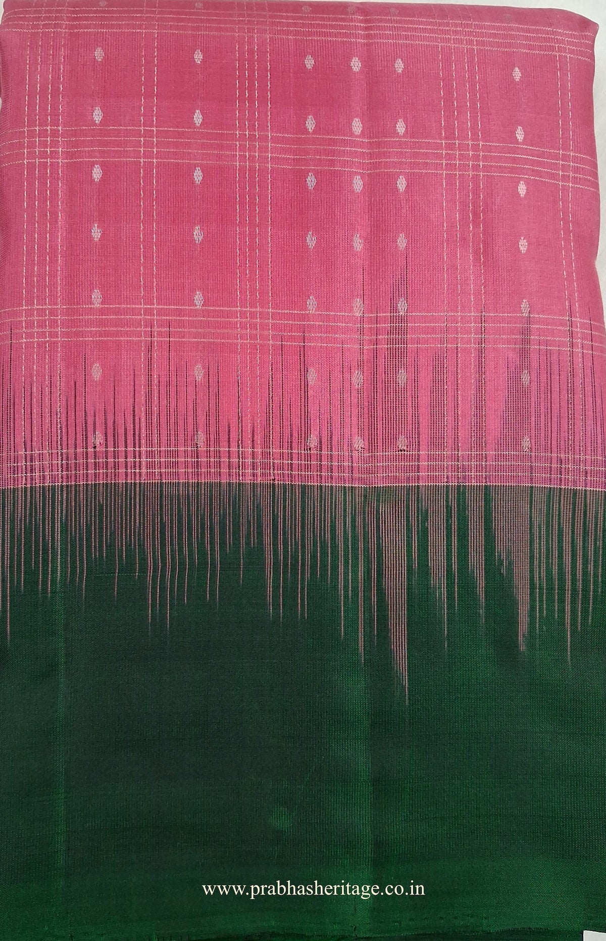 Malar Vana Tarangini short-folded to show the checked body and bottle-green border