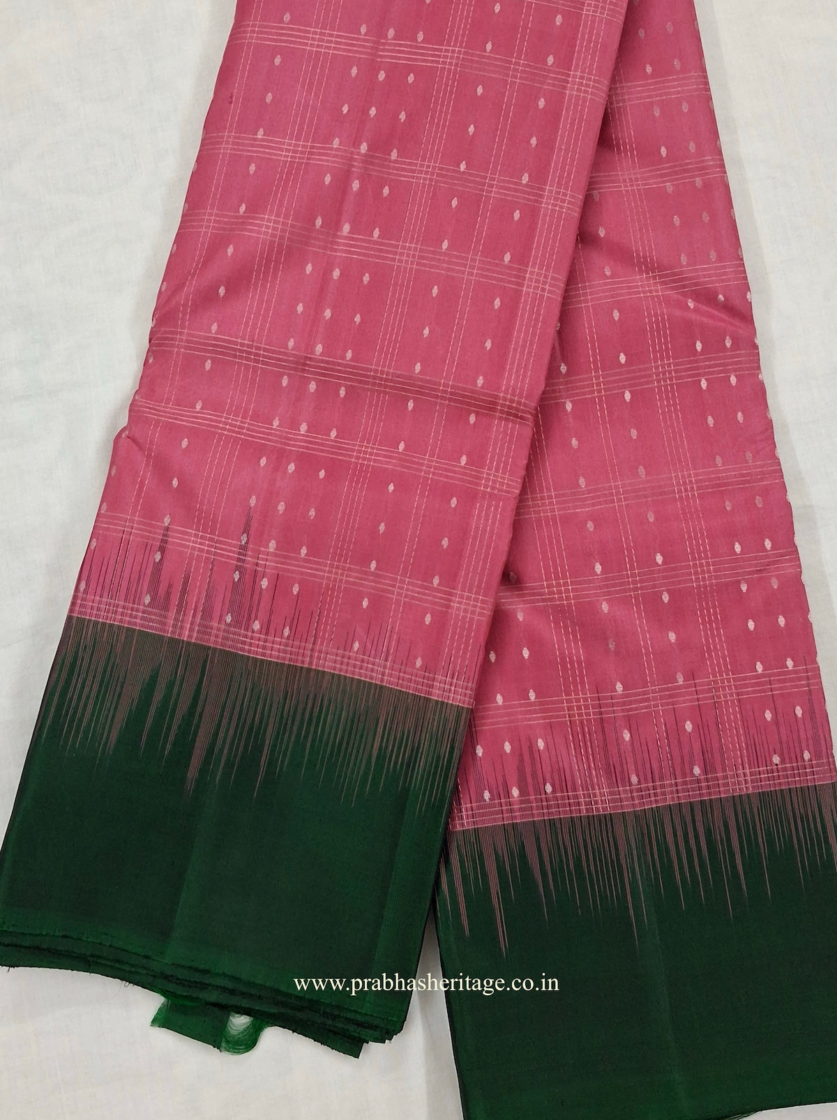 Full length of the saree long-folded, showing the rose-pink body and bottle-green pallu