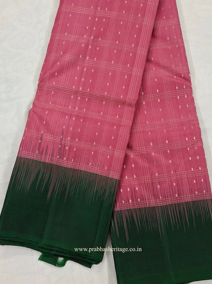Full length of the saree long-folded, showing the rose-pink body and bottle-green pallu