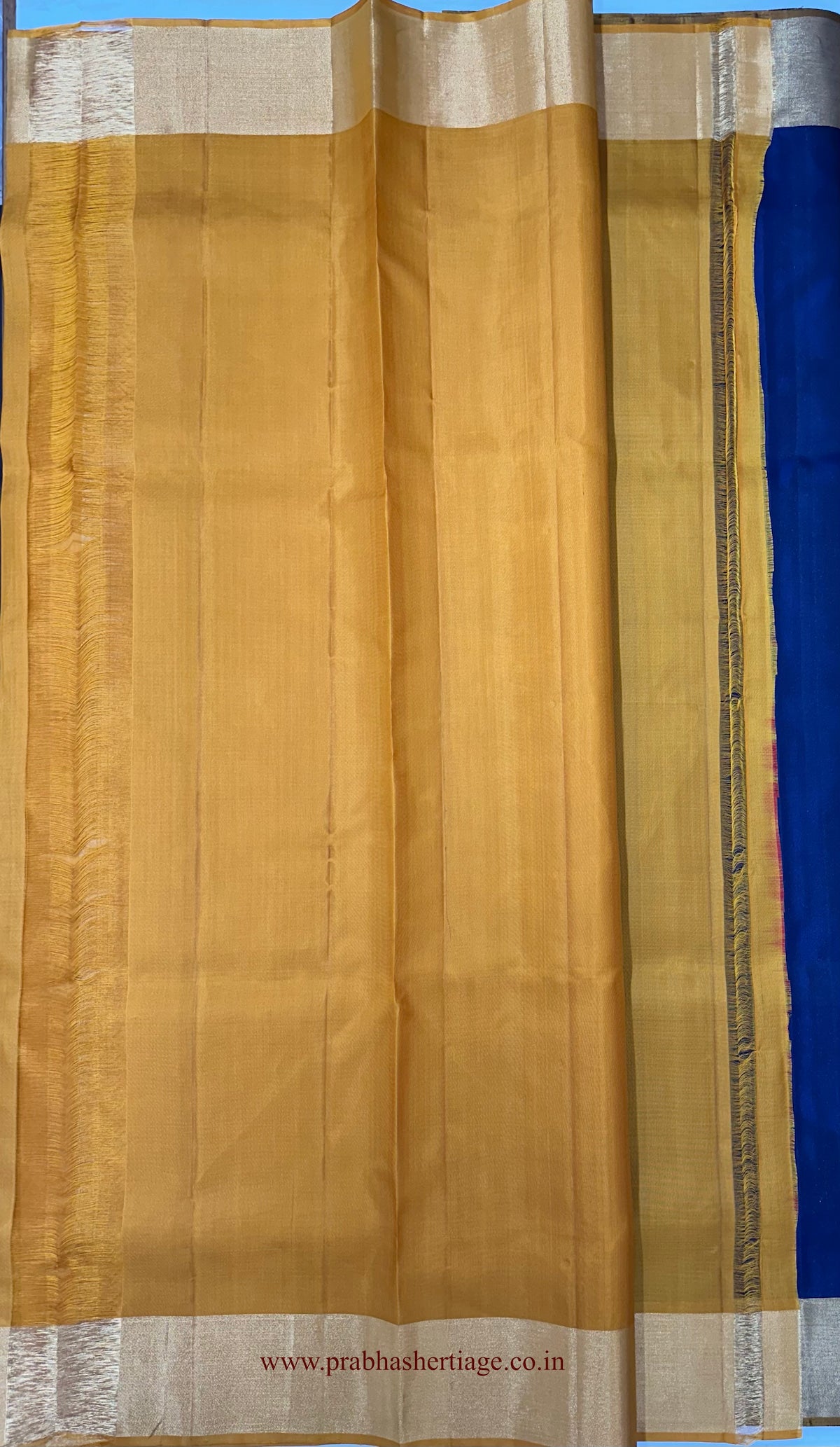 Plain mustard-gold blouse piece with zari borders