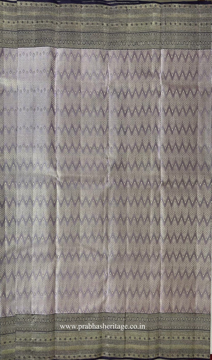 Chevron zari pattern on the silvery lavender silk body of the saree