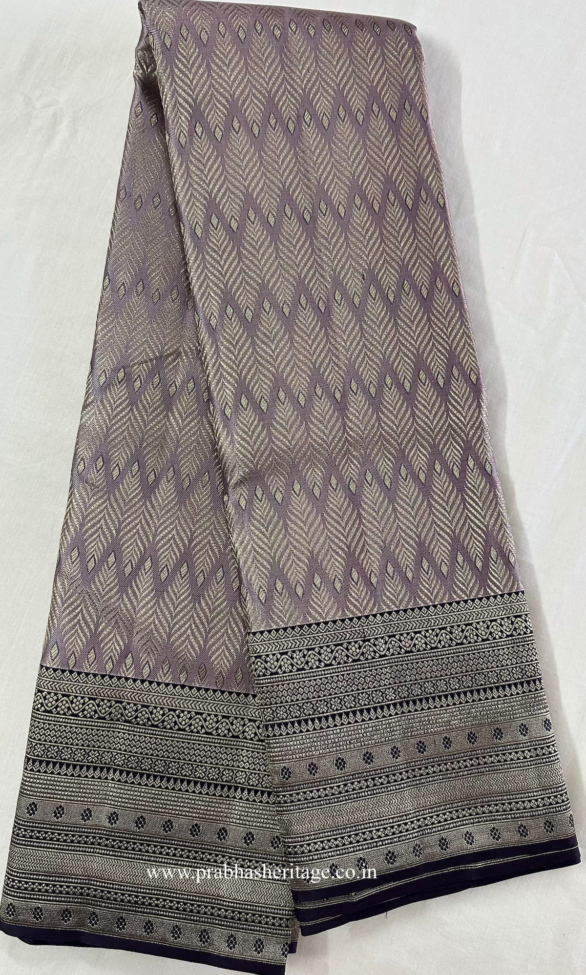 Full length of the saree shown as a long fold, with body, border and pallu visible