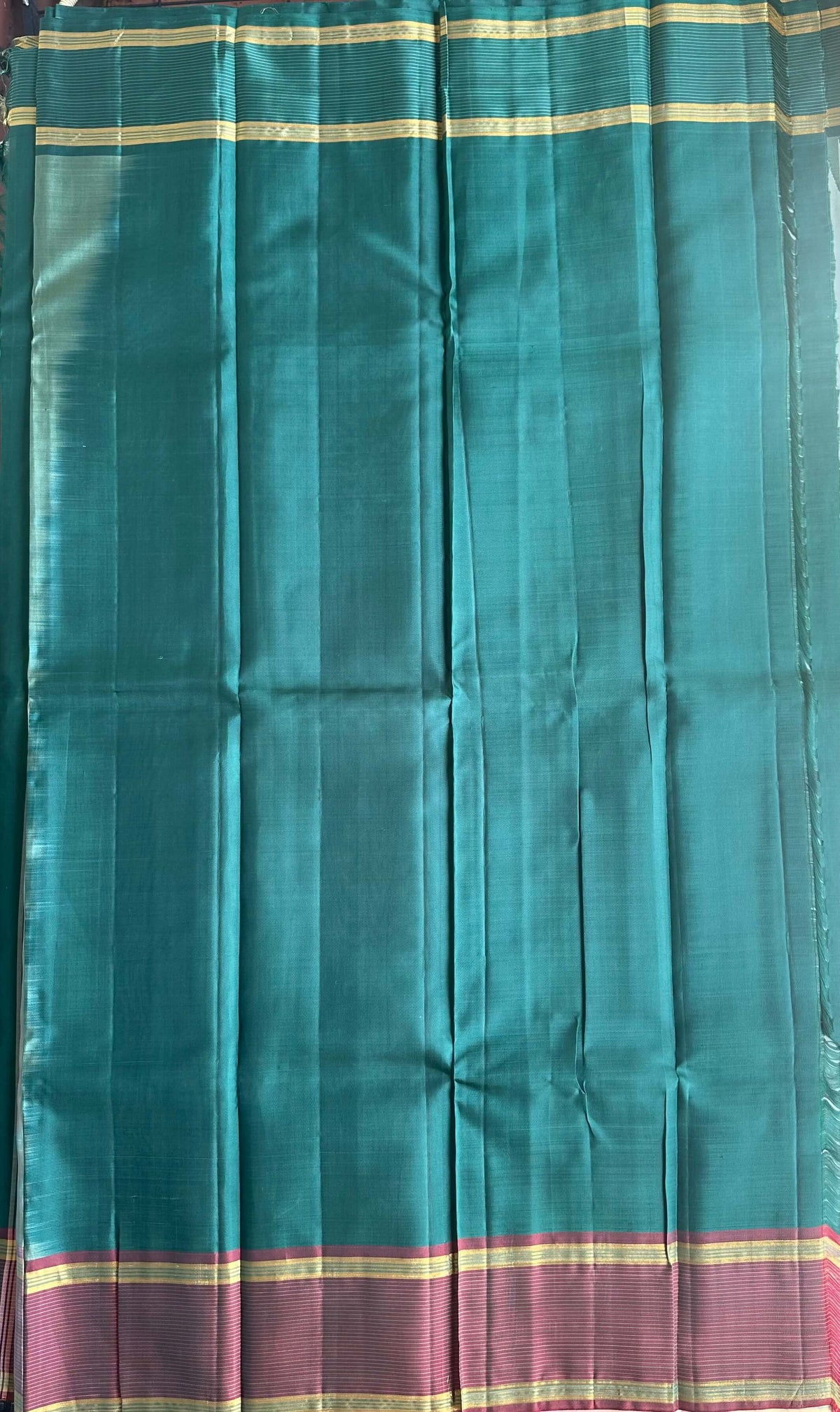 Attached contrast running blouse with an emerald green zari border