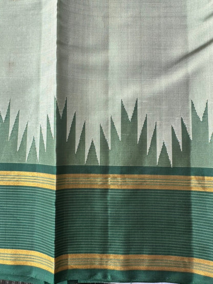Korvai temple border where the ivory sage body meets the emerald green zari border
