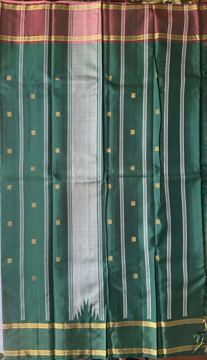 Emerald green and rose-mauve pallu worked in gold zari on an ivory sage silk saree