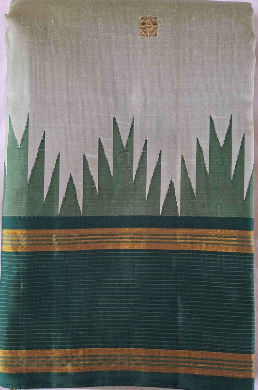 Ivory sage Kanchipuram silk saree folded to show the body and emerald green border