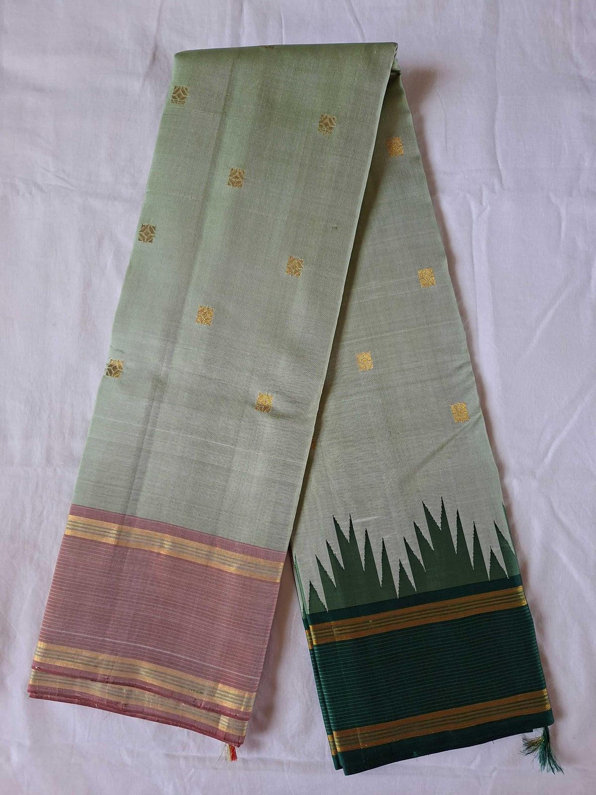 Full length of the ivory sage Kanchipuram silk saree with its dual contrast Korvai borders