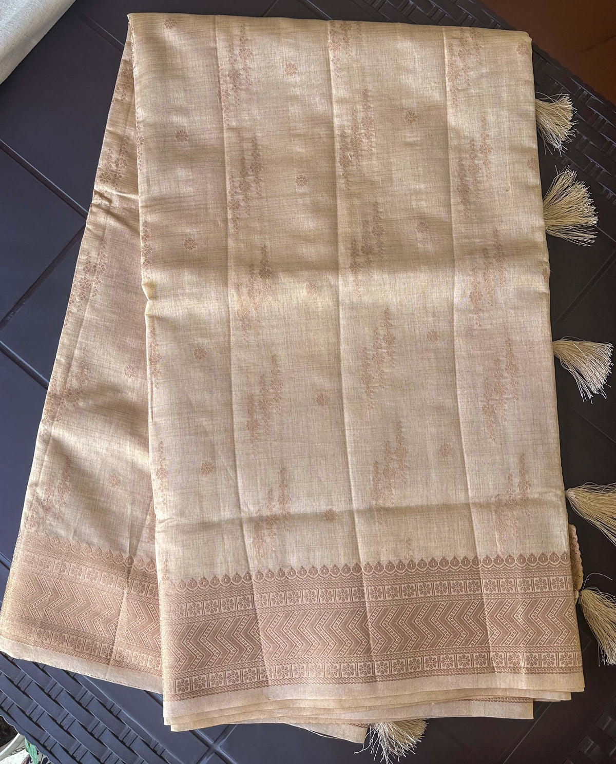 Long fold view of Chandana Varnam sand beige semi-tussar saree with chevron zari border
