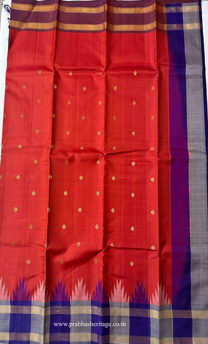 Korvai temple border with colour-blocked checks where the vermilion-orange body meets the border