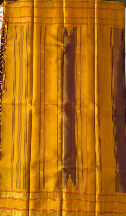 Mustard-gold pallu worked in refined zari on a violet Kanchipuram silk saree