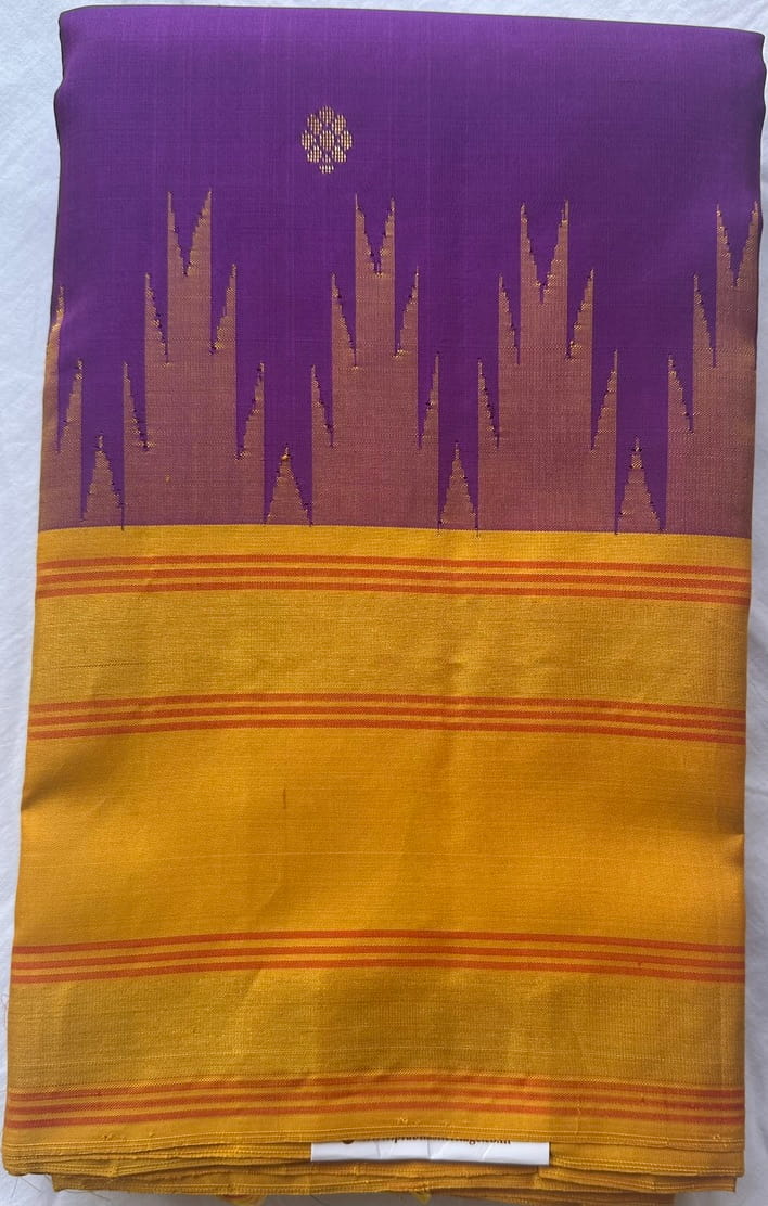 Violet Kanchipuram silk saree folded to show the body and mustard-gold border