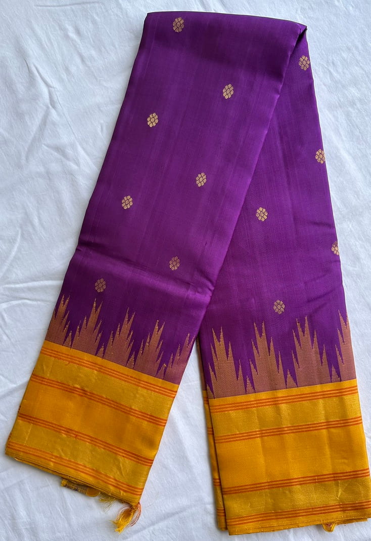Close view of a gold zari butta on the violet silk body of the Vaibhava Rekha saree