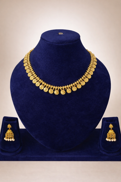 Lakshmi Kasu temple necklace with matching Jhimikki earrings displayed on a blue velvet jewellery mannequin.